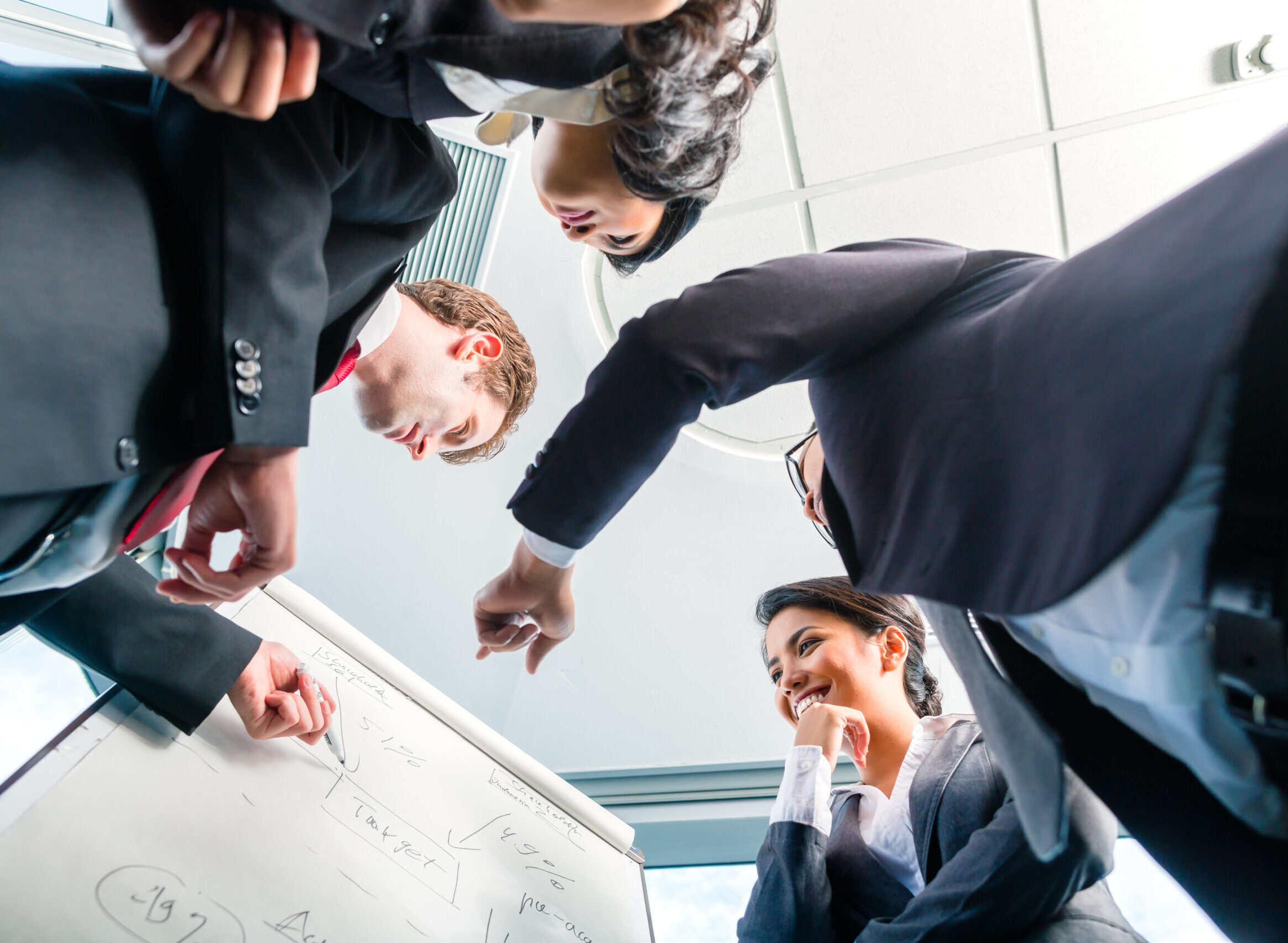 Asian Businesspeople looking at flipchart